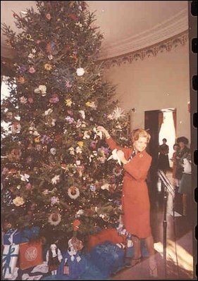 First Lady hanging the last ornaments to the Christmas tree.