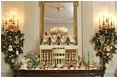 The Gingerbread House sits on a buffet in the State Dining Room. This year's Gingerbread House is made from 100 pounds of gingerbread and 150 pounds of chocolate.
