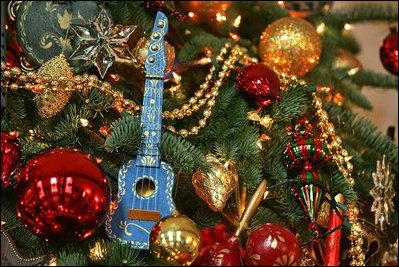Over 350 instrument ornaments hang on the 2004 Blue Room Christmas tree along with almost 400 Christmas balls.