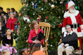 Brandy Robinson, Laura Bush , Barney Bush Keith "Koddie" Hernandez and Santa Claus watch the first viewing of the 2004 BarneyCam during the Children's National Medical Center holiday program in Washington, D.C., Wednesday, Dec. 15, 2004. 