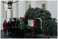 Laura Bush receives the official White House Christmas tree delivered on a horse drawn wagon Monday, Nov. 29. 2004. The 18.5 foot Noble fir donated by John and Carol Tillman of Rochester, Wash., will be decorated and displayed in the Blue Room. 