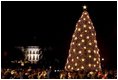 The National Christmas tree stands lit on the Ellipse in front of the White House Dec. 2, 2004. President George W. Bush and Laura Bush assisted Chantilly, Va., Girl Scout Brownies Clara Pitts and Nichole Mastracchio in lighting the 40-foot Colorado blue spruce. 
