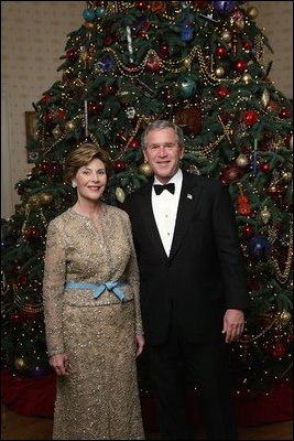 President George W. Bush and Laura Bush pose for their annual Christmas portrait in front of the Blue Room Christmas tree Dec. 5, 2004. 