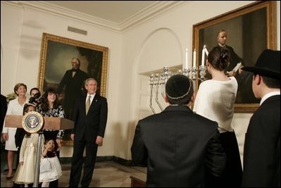 President George W. Bush and Laura Bush watch the lighting of the Menorah at the White House Thursday, Dec. 9, 2004. "We are honored to celebrate the miracle of Hanukkah in the White House this evening," said the President. 