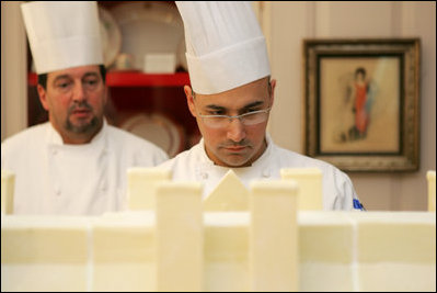 Thaddeus DuBois, Head Pastry Chef, inspects the roof on top of the official White House gingerbread house.