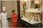 Laura Bush is shown the White House gingerbread house by White House pastry chef Thaddeus DuBois, on display in the State Dining Room.