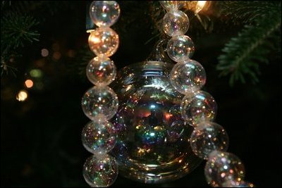 A shimmering glass decoration is seen on the White House Christmas Tree, a large Fraser Fir, in the Blue Room of the White House, Tuesday, Nov. 29, 2005.
