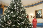 Mrs. Laura Bush stands next to the Blue Room Christmas tree, Wednesday, Nov. 30, 2005, as she answers questions during the press preview of the White House Christmas decorations.