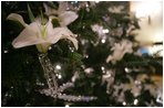 A lily flower decoration is seen on the White House Christmas Tree, a large Fraser Fir, in the Blue Room of the White House, Monday, Nov. 28, 2005. 