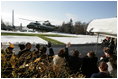 Visitors wave as President Bush takes off in Marine One from a snow-covered South Lawn Friday, Dec. 9, 2005.