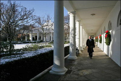 President George W. Bush takes a brisk walk along the colonnade in the Rose Garden Friday morning, Dec. 9, 2005.