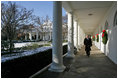 President George W. Bush takes a brisk walk along the colonnade in the Rose Garden Friday morning, Dec. 9, 2005.