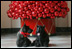Barney and Miss Beazley pose beneath a decorative red ornament Christmas Tree, Wednesday, Nov. 29, 2006, in the East Wing of the White House.