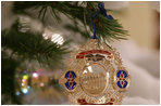 A White House Christmas ornament hangs from a branch on the official White House Christmas tree Wednesday, Nov. 29, 2006, an 18-foot Douglas fir on display in the Blue Room of the White House. 