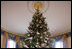 The official White House Christmas tree, an 18-foot Douglas fir tree donated by the Crystal Springs Tree Farm of Lehighton, Pa., stands in the Blue Room of the White House, Thursday, Nov. 30, 2006.