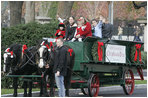 A horse-drawn wagon carrying the official White House Christmas tree is guided up the White House driveway Monday, Nov. 27, 2006, by members of the Botek family of Lehighton, Pa. The Botek family owns Crystal Springs Tree Farm and donated the 18-foot Douglas fir tree. 