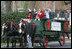 A horse-drawn wagon carrying the official White House Christmas tree is guided up the White House driveway Monday, Nov. 27, 2006, by members of the Botek family of Lehighton, Pa. The Botek family owns Crystal Springs Tree Farm and donated the 18-foot Douglas fir tree. 