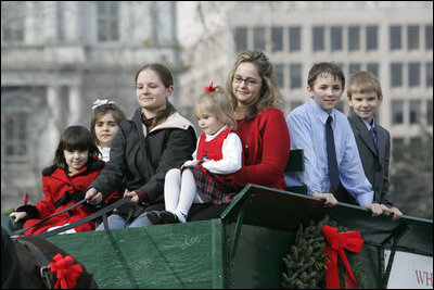 Members of the Botek family of Lehighton, Pa., ride the horse-drawn wagon delivering the official White House Christmas tree Monday, Nov. 27 , 2006, an 18-foot Douglas fir tree donated by the Botek family, owners of the Crystal Springs Tree Farm in Lehighton, Pa. 