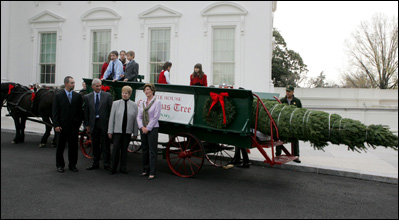 Mrs. Laura Bush stands with the Botek family of Lehighton, Pa., as she receives the official White House Christmas tree on the North Portico Monday, Nov. 27, 2006. The Botek family owns the Crystal Springs Tree Farm and donated the 18-foot Douglas fir tree. 