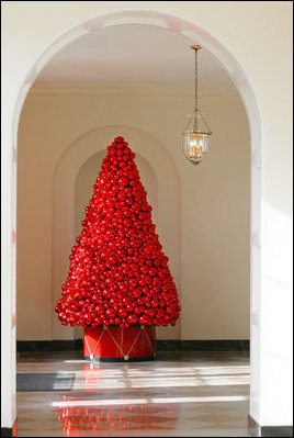 Inspired by holly berries, decorators created brilliant, red tree sculptures from hundreds of polished glass spheres to greet visitors walking along the East Colonnade.