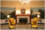Evergreen garland is draped across the fireplace mantle in the Diplomatic Reception Room.