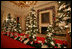 A row pine of trees line the center table of the State Dinning Room where 20,000 Christmas cookies, 15,000 Chocolate Truffles, 3,000 racks of lamb, 500 Filets of Beef, and will be served to the 45,000 guests visiting the White House during the Holiday season.