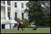 Barney leads the way as President George W. Bush carries Barney’s favorite soccer ball out to play on the South Lawn of the White House, Sunday, Nov. 25, 2007.