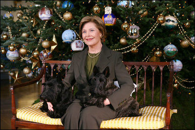 Mrs. Laura Bush sits with Barney and Miss Beazley before the White House Christmas tree, Wednesday, Nov. 30, 2007, in the Blue Room of the White House.