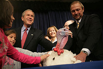 President George W. Bush invites children on stage, Tuesday, November 22, 2005, to pet 'Marshmallow', the National Thanksgiving Turkey, at the official pardoning of the turkey at the Eisenhower Executive Office Building in Washington. White House photo by David Bohrer 