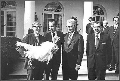 Photograph of President Nixon receiving a Thanksgiving turkey from members during the annual pardoning ceremony.