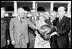 Photograph of President Truman receiving a Thanksgiving turkey from members of the Poultry and Egg National Board and other representatives of the turkey industry,outside the White House. 