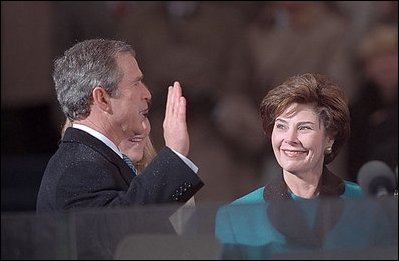 George W. Bush takes the oath of office, administered by U.S. Supreme Court Chief Justice William Rehnquist (not pictured), to become President of the United States at the U.S. Capitol, Jan. 20, 2001.