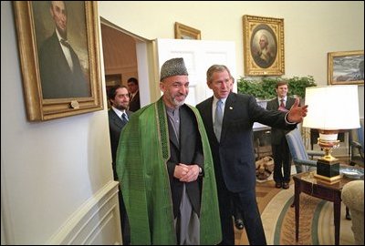 President George W. Bush welcomes then-Chairman of the Afghan Interim Authority Hamid Karzai to the Oval Office Jan. 28, 2002.