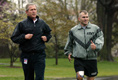 President George W. Bush runs with U.S. Army Staff Sergeant Michael McNaughton of Denham Springs, La., on the South Lawn of the White House Wednesday, April 14, 2004. The two met January 17, 2003 at Walter Reed Army Medical Center where SSgt. McNaughton was recovering from wounds sustained in Iraq. The President then wished SSgt. McNaughton a speedy recovery so that they might run together in the future.
