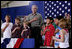 President George W. Bush joins a group of children during the Pledge of Allegiance Wednesday, July 4, 2007, at a Fourth of July visit with members of the West Virginia Air National Guard 167th Airlift Wing and their family members in Martinsburg, W. Va. White House photo by Chris Greenberg