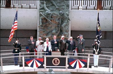 President George W. Bush joins fellow veterans in standing at attention during the playing of the National Anthem at the dedication of the National D-Day Memorial in Bedford, Va., June 6, 2001. The memorial was built to honor those who served and died during Operation Overlord in the D-Day invasion at Normandy, France, June 6, 1944.