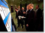 President George W. Bush looks over the newly created list of Most Wanted Terrorists with FBI Director Rober Mueller at the agency's headquarters