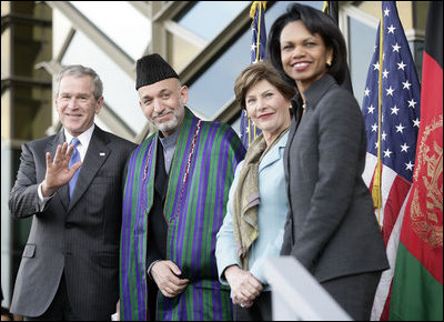 President George W. Bush waves as he stands with President Hamid Karzai of Afghanistan, Mrs. Laura Bush and Secretary of State Condoleezza Rice during welcoming ceremonies Wednesday, March 1, 2006, in Kabul.