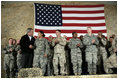 President George W. Bush meets and thanks a group of U.S. and Coalition troops, Wednesday, March 1, 2006, during a visit to Bagram Air Base in Afghanistan, where President Bush thanked the troops for their service in defense of freedom.