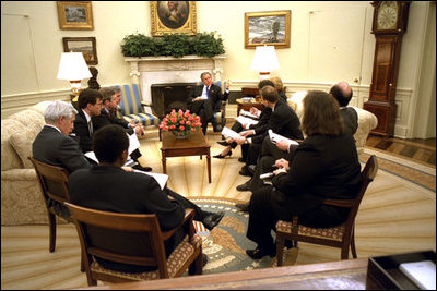 One day after announcing his plan, President George W. Bush discusses the AIDS policy with advisors in the Oval Office Jan. 29, 2003. "We believe in the value and dignity of every human life," said the President during the bill's May 27th signing ceremony. "In the face of preventable death and suffering, we have a moral duty to act, and we are acting."