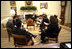 One day after announcing his plan, President George W. Bush discusses the AIDS policy with advisors in the Oval Office Jan. 29, 2003. "We believe in the value and dignity of every human life," said the President during the bill's May 27th signing ceremony. "In the face of preventable death and suffering, we have a moral duty to act, and we are acting."