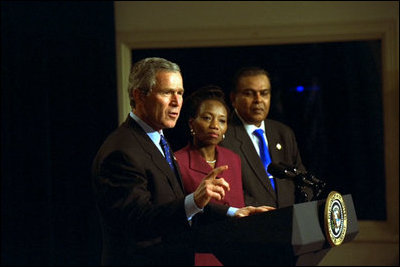 President George W. Bush discusses Global and Domestic HIV and AIDS during a meeting in the Dwight D. Eisenhowser Executive Office Building Jan. 31, 2003. Pictured with the President are Ambassodor Edith Ssempala of Uganda, center, and Ambassador Odeen Ishmael of Guyana.