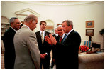 President Bush discusses the HIV/AIDS Bill with, from left, Secretary of State Colin Powell, and Senators Joseph Biden, Bill Frist and Richard Lugar in the Oval office May 8, 2003.
