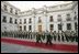 President George W. Bush walks with President Ricardo Lagos of Chile past a unit of Carabineros at the La Moneda Presidential Palace upon arrival for a meeting and private dinner in Santiago, Chile, Nov. 21, 2004. 