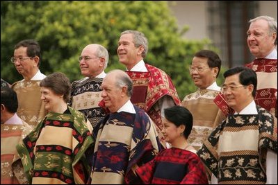 President George W. Bush smiles for a group photo with APEC leaders at La Moneda Presidential Palace in Santiago, Chile, Nov. 21, 2004. 