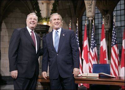Before a bilateral session at Parliament Hill, President George W. Bush and Canadian Prime Minister Paul Martin meet in the rotunda in Ottawa, Canada, Nov. 30, 2004.