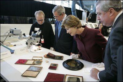 President George W. Bush and Laura Bush get a close look at some of the artifacts at the Canadian National Archives Gatineau Preservation Centre in Gatineau, Québec, Nov. 30, 2004. 