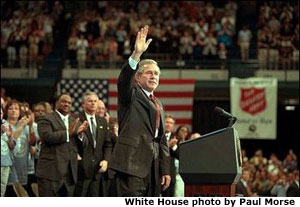 President George W. Bush waves during his visit to the Knoxville Civic Center in Knoxville, Tenn., Monday, April 8. Listing several specific ways Americans can volunteer, the president spoke about the value and need of community service. To learn more, call 1-877-USA-CORPS