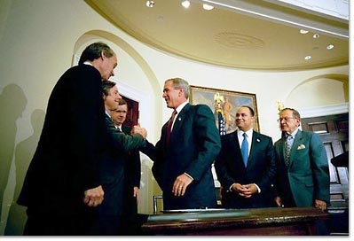 President George W. Bush signs the Do Not Call Registry in the Roosevelt Room Sept. 29, 2003. Pictured with the President are, from left, Rep. Edward Markey, D-Mass.; Rep. Fred Upton, R-Mich.; Federal Trade Commission Chairman Timothy Muris; Rep. Billy Tauzin, R-La. (behind President Bush); Federal Communications Commission Chairman Michael Powell; and Sen. Ted Stevens, R-Alaska. 