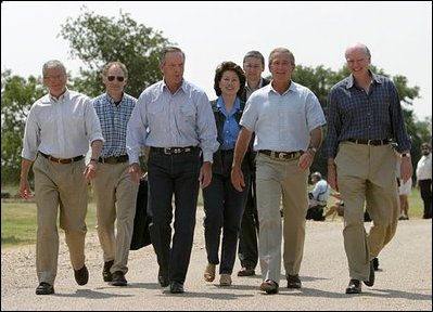 After talking with the press, President George W. Bush walks with his economic advisors at his ranch in Crawford, Texas, Aug. 13, 2003. Pictured are, from left, Director of the Office of Management and Budget Josh Bolten, Assistant to the President for Economic Policy Stephen Friedman, Secretary of Commerce Don Evans, Secretary of Labor Elaine Chao and Secretary of the Treasury John Snow. 
